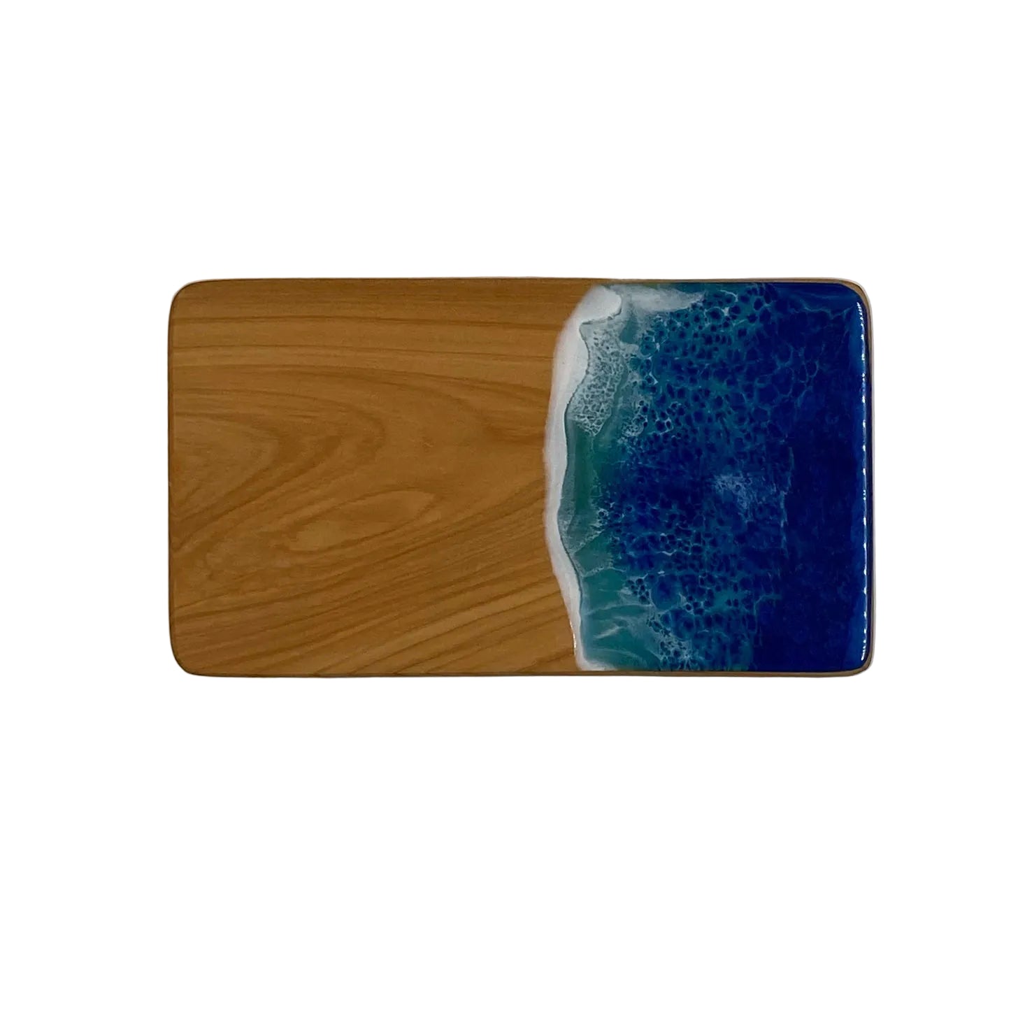 A small rectangular serving board with a resin top featuring an ocean design in blue and white colors, and a wooden base.