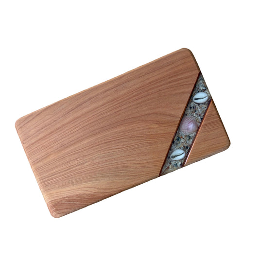Wooden serving board with embedded shells in resin